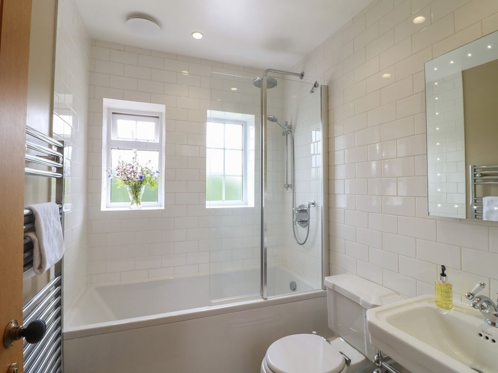 A bathroom with a shower and bathtub at Ivet Lowe in Hopton near Wirksworth
