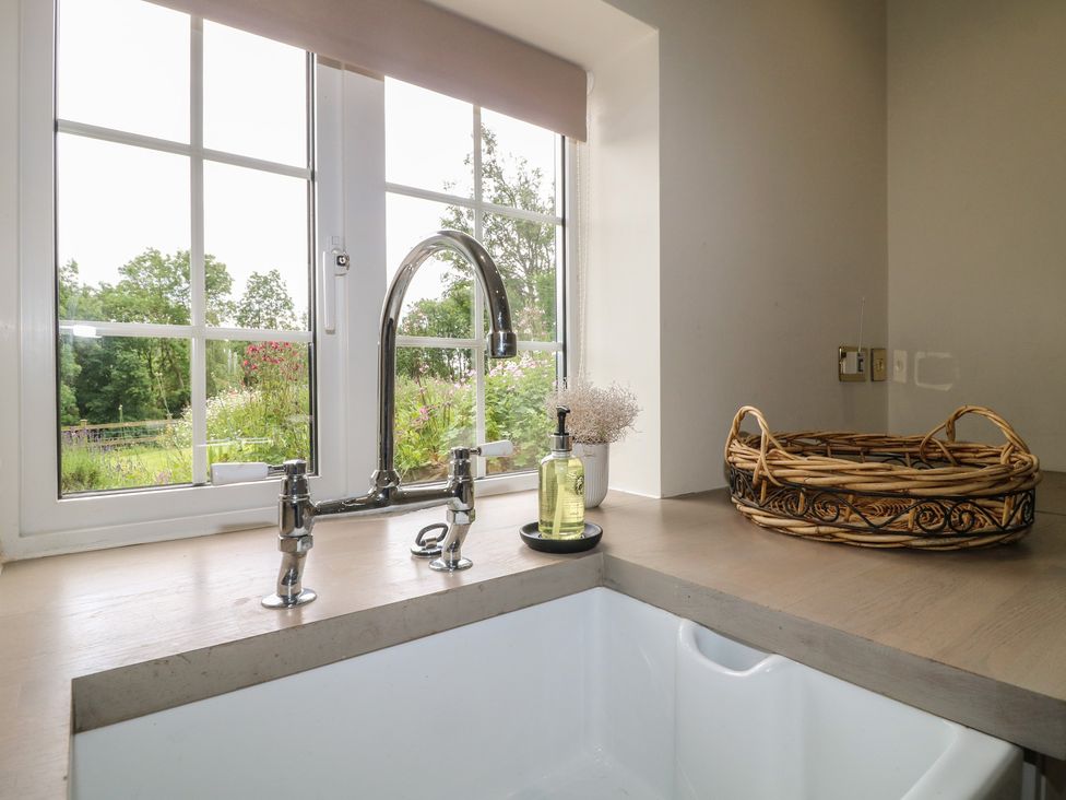 A kitchen sink with a faucet and a window at Ivet Lowe Hopton near Wirksworth