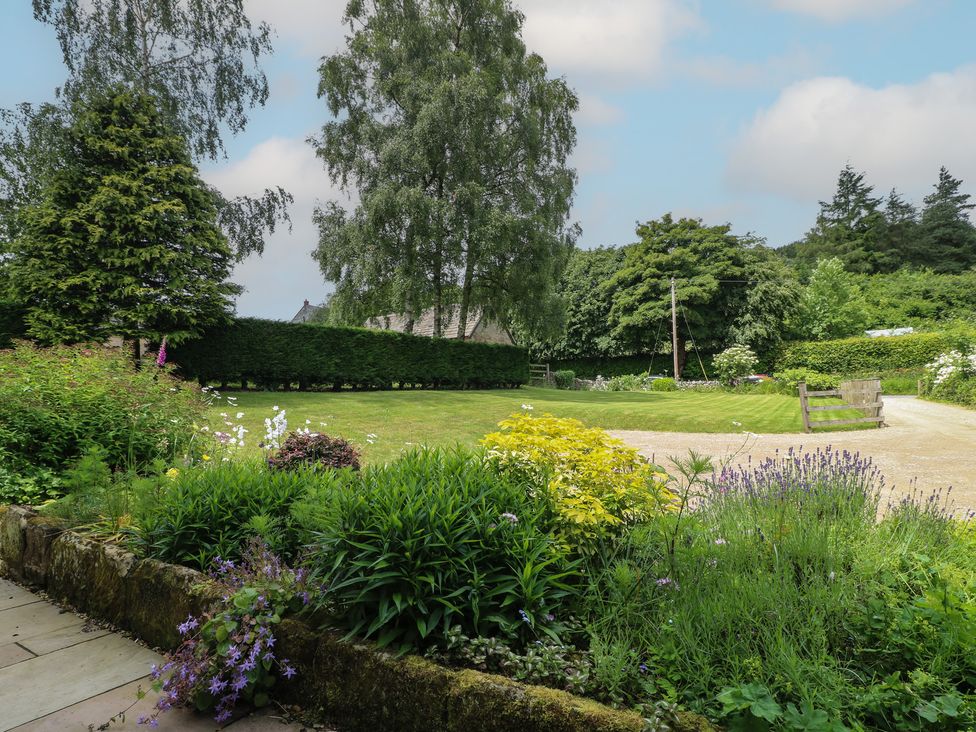 A garden with various plants and a gravel pathway at Ivet Lowe in Hopton near Wirksworth