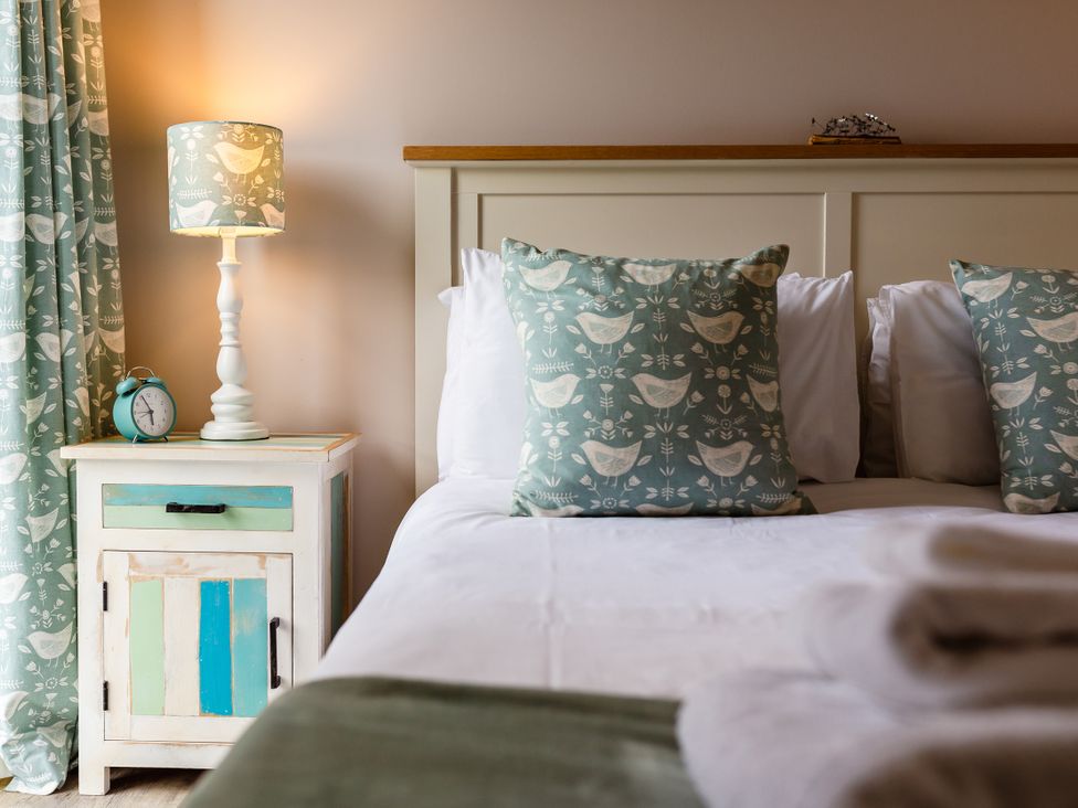 A bedroom with a bed and nightstand at Betony in Bamburgh