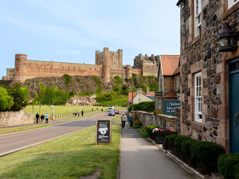 A view of a castle from a road in Bamburgh