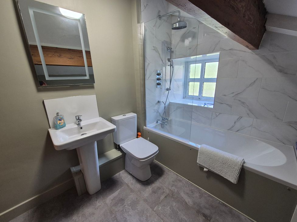 A bathroom with a shower, sink, and toilet at Dale View in Buckden