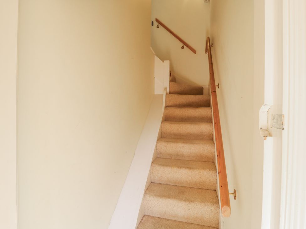 A staircase with handrail at Over Village Studio in Over