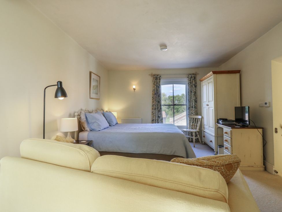 A bedroom with a bed and furniture at Over Village Studio in Over