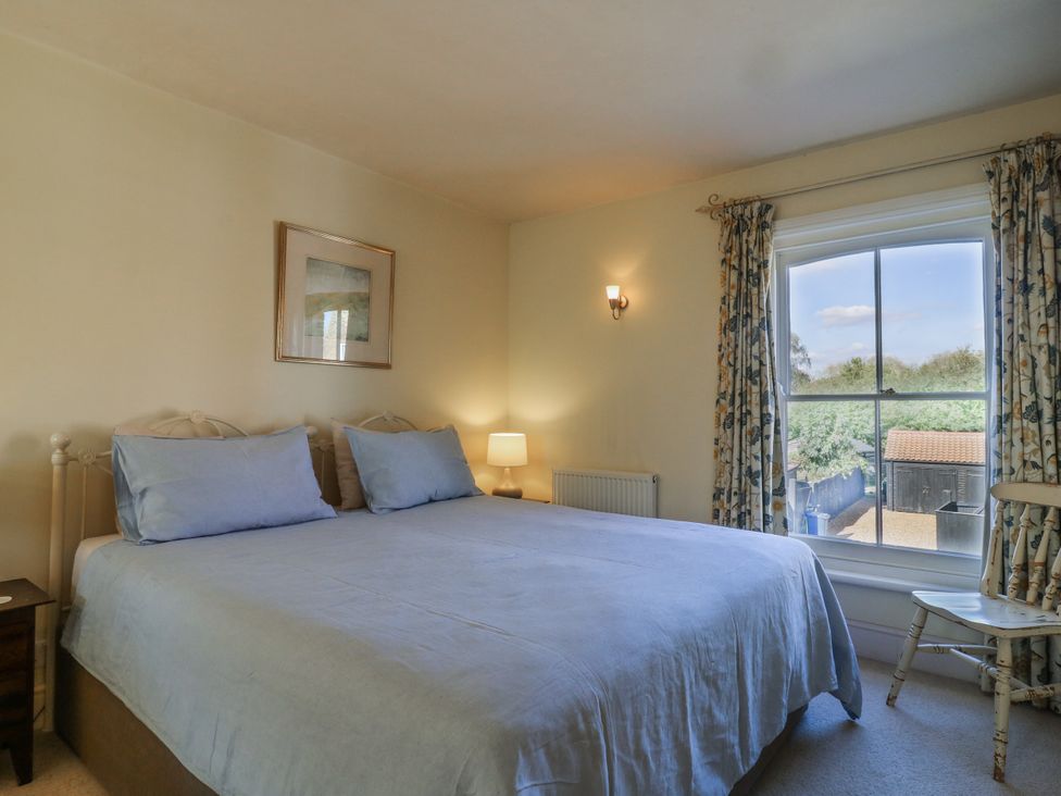A bedroom with a bed and window at Over Village Studio in Over
