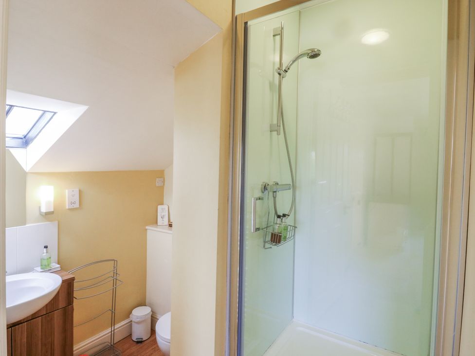 A bathroom with a shower and sink at Over Village Studio in Over