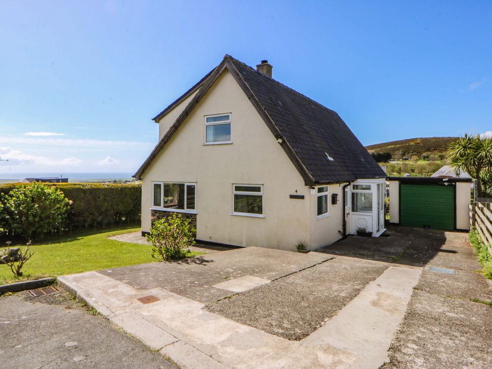 A house with a garden and driveway at Pen Y Garth in Mynytho near Llanbedrog