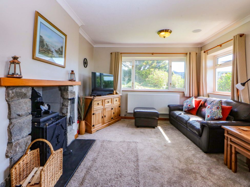 A living room with a sofa and television at Pen Y Garth, Mynytho near Llanbedrog