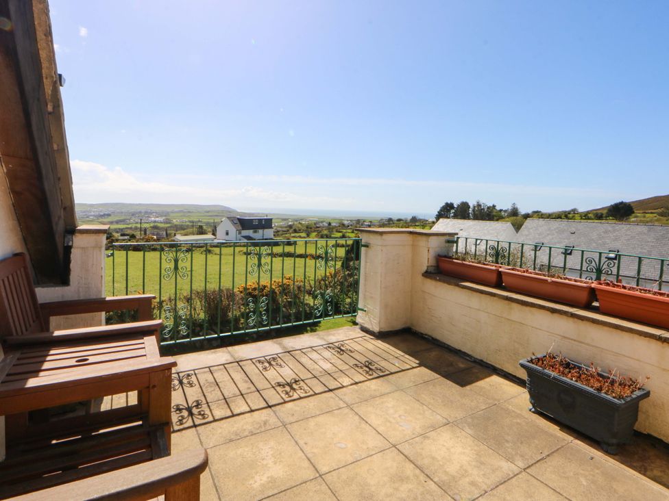 A balcony with seating and view at Pen Y Garth Mynytho near Llanbedrog