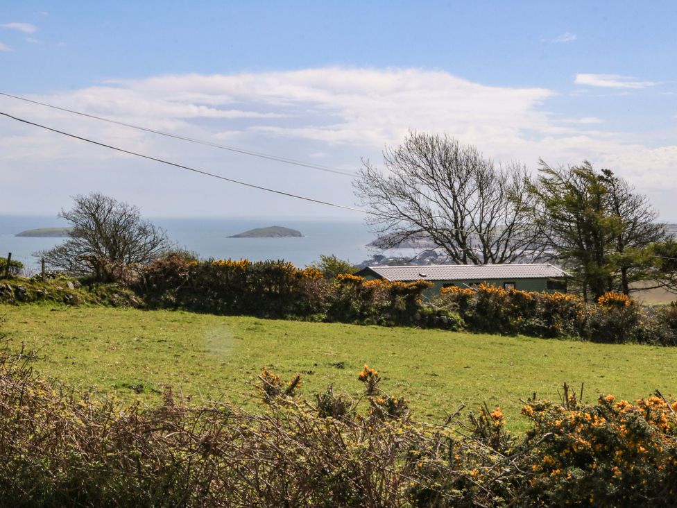 A view of the sea with islands and greenery at Pen Y Garth Mynytho near Llanbedrog