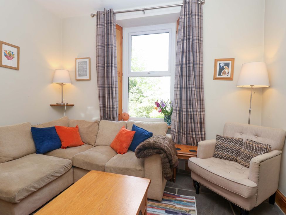 A living room with a sofa and a coffee table at Holcombe House in Torquay