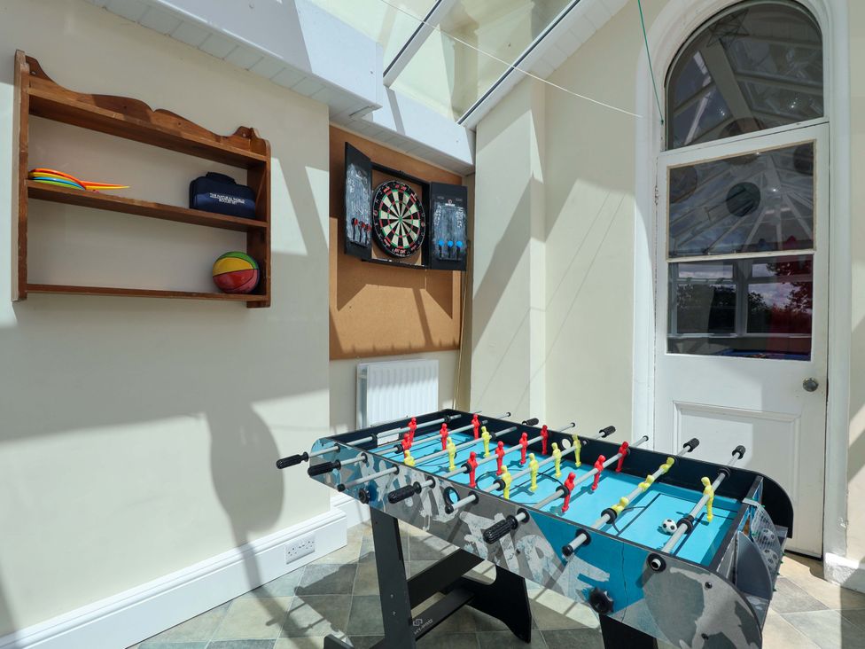 A games room with a foosball table and dartboard at Holcombe House in Torquay