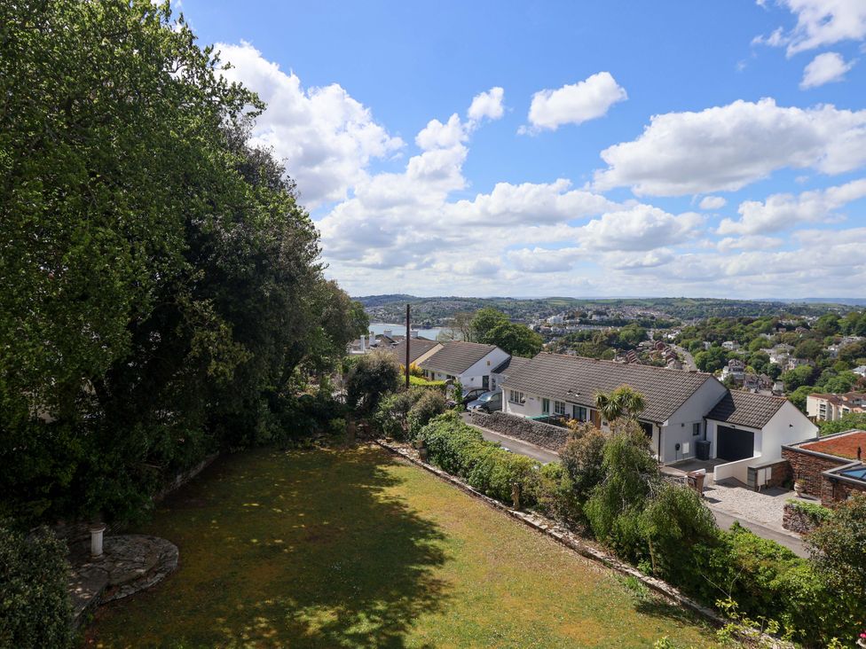 A garden with grass and trees at Holcombe House in Torquay