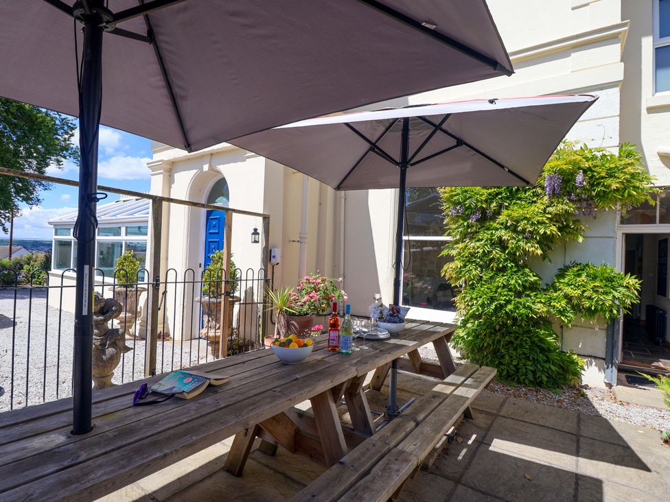 An outdoor area with a table and beverages at Holcombe House in Torquay