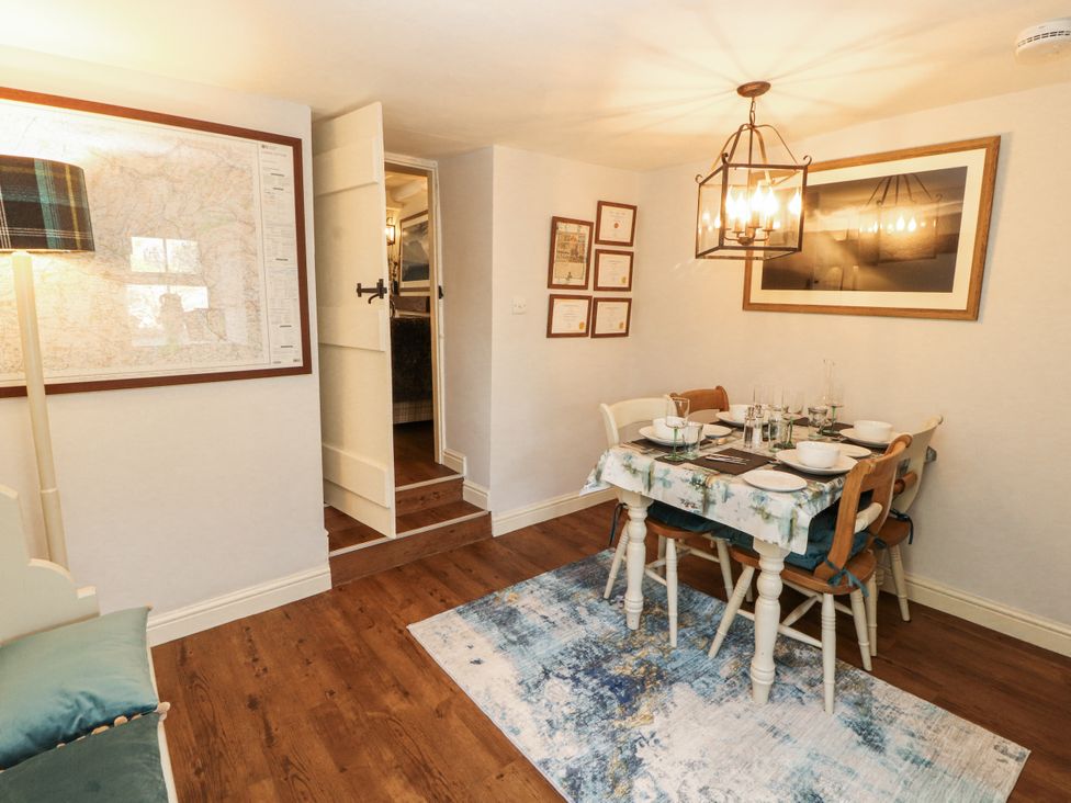 A dining room with a table set for dinner at Corner Cottage Ingleton