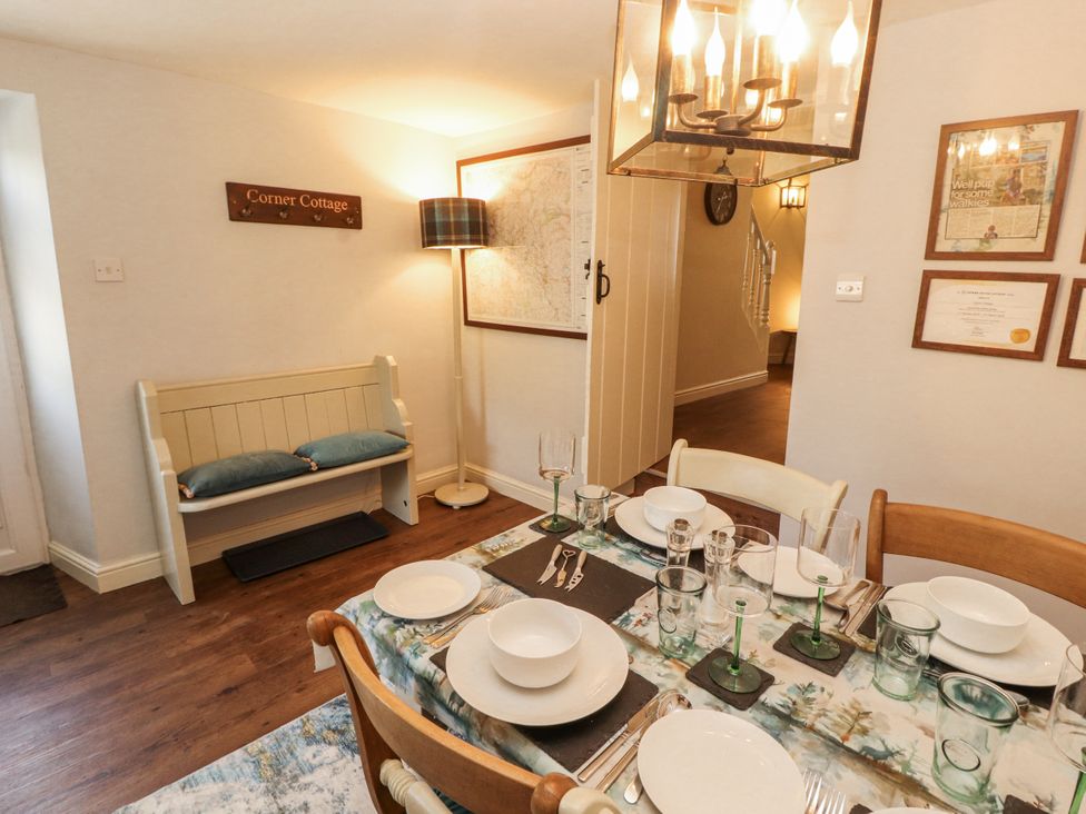 A dining room with a table set for dinner at Corner Cottage Ingleton