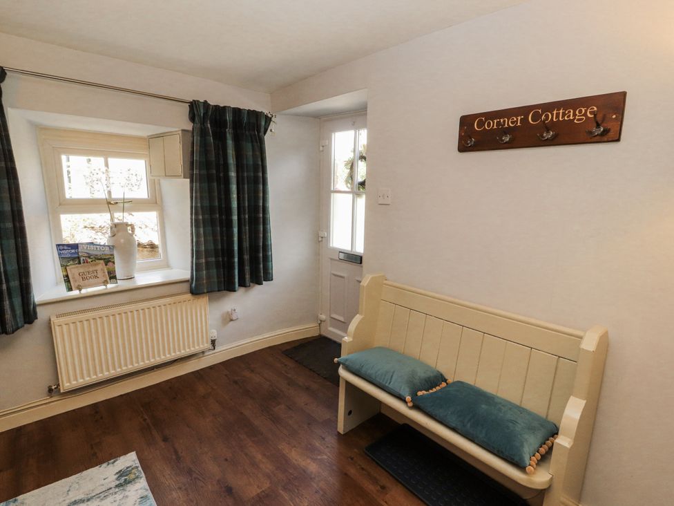 A hallway with a bench and window at Corner Cottage Ingleton