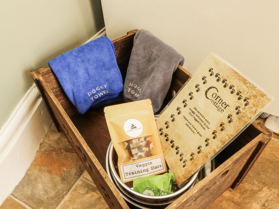 A storage box with dog towels and treats at Corner Cottage in Ingleton