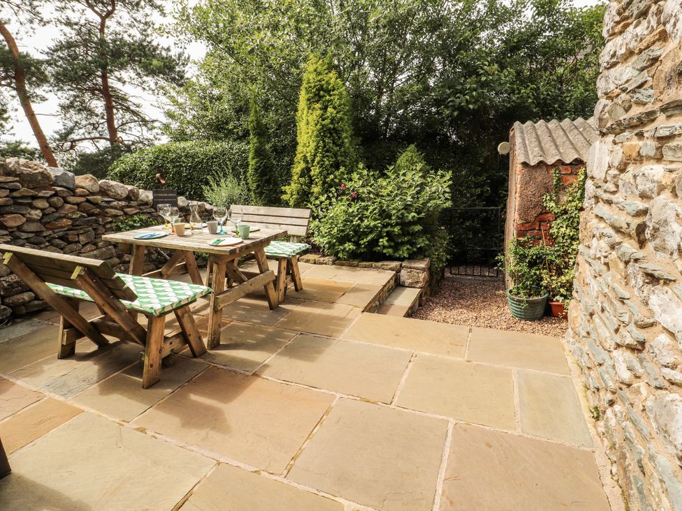 An outdoor area with a table and chairs at Corner Cottage Ingleton