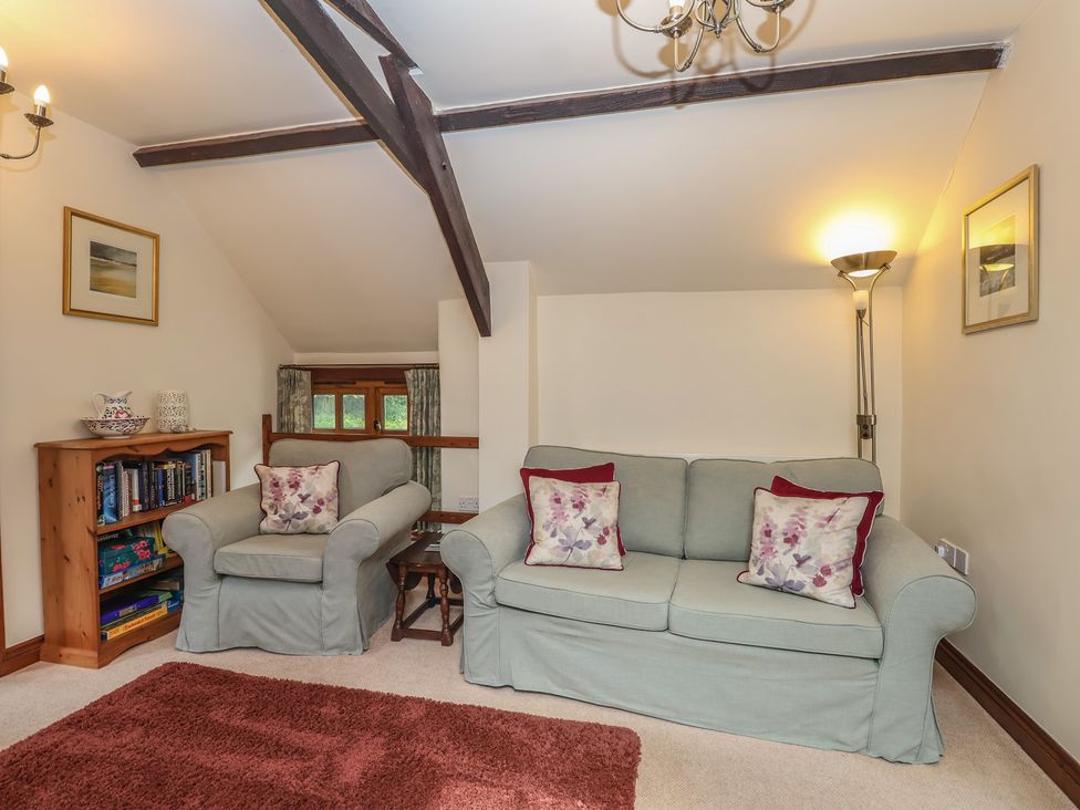 A living room with a sofa and armchairs at The Coach House in Kingston