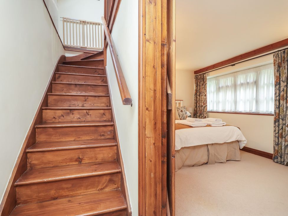A bedroom with a bed and stairs at The Coach House in Kingston