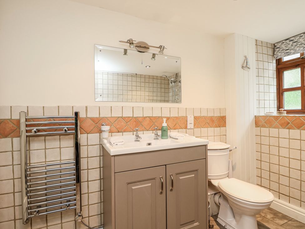 A bathroom with sink and toilet at The Coach House in Kingston