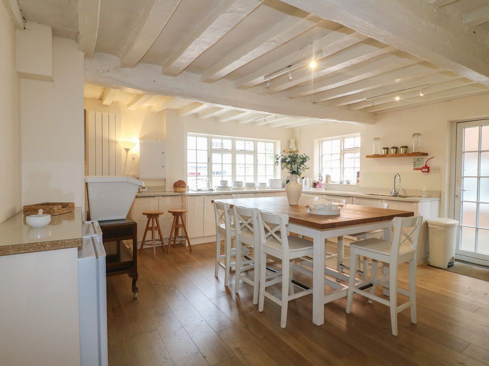 A kitchen with a table and chairs at Hambleton House in Castle Donington