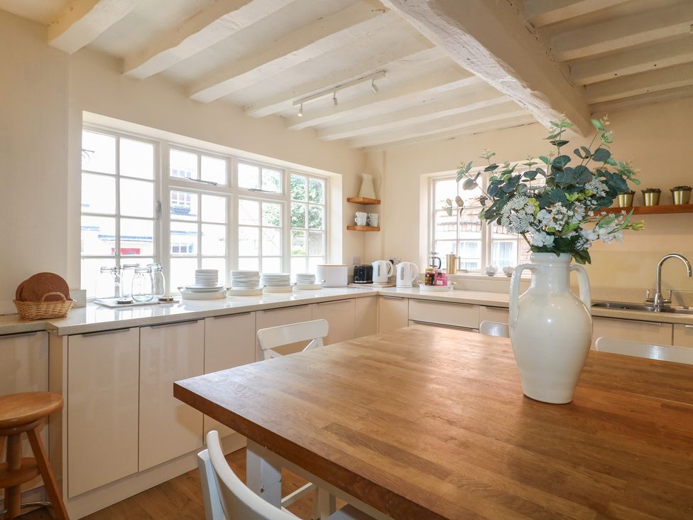 A kitchen with a table and chairs at Hambleton House in Castle Donington