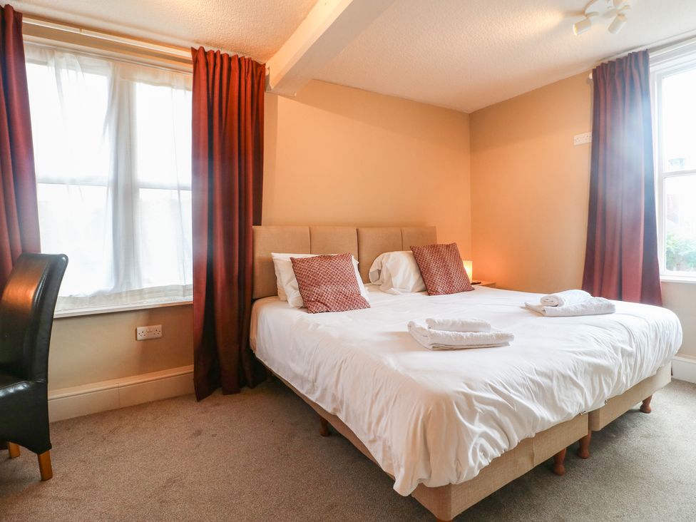 A bedroom with a bed and chair at Hambleton House in Castle Donington