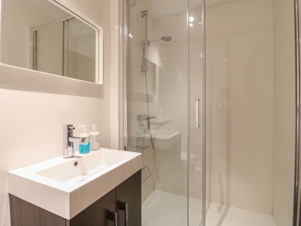 A bathroom with a shower and sink at Hambleton House in Castle Donington