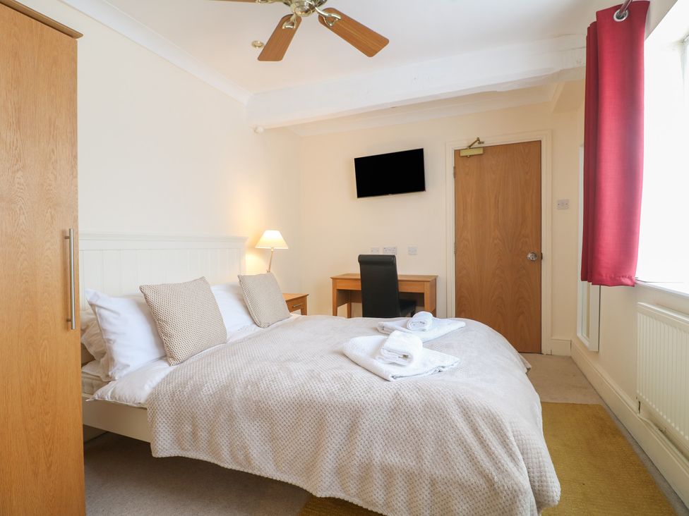 A bedroom with a bed and desk at Hambleton House in Castle Donington