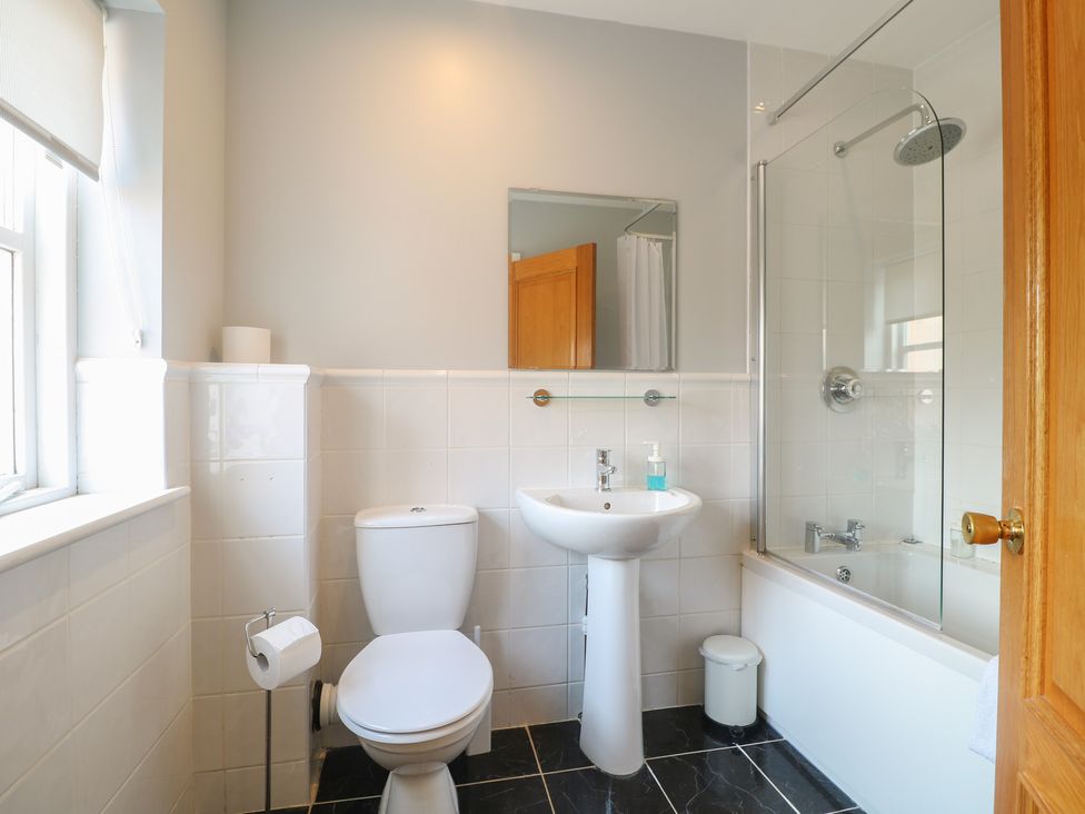 A bathroom with a shower and bathtub at Hambleton House in Castle Donington