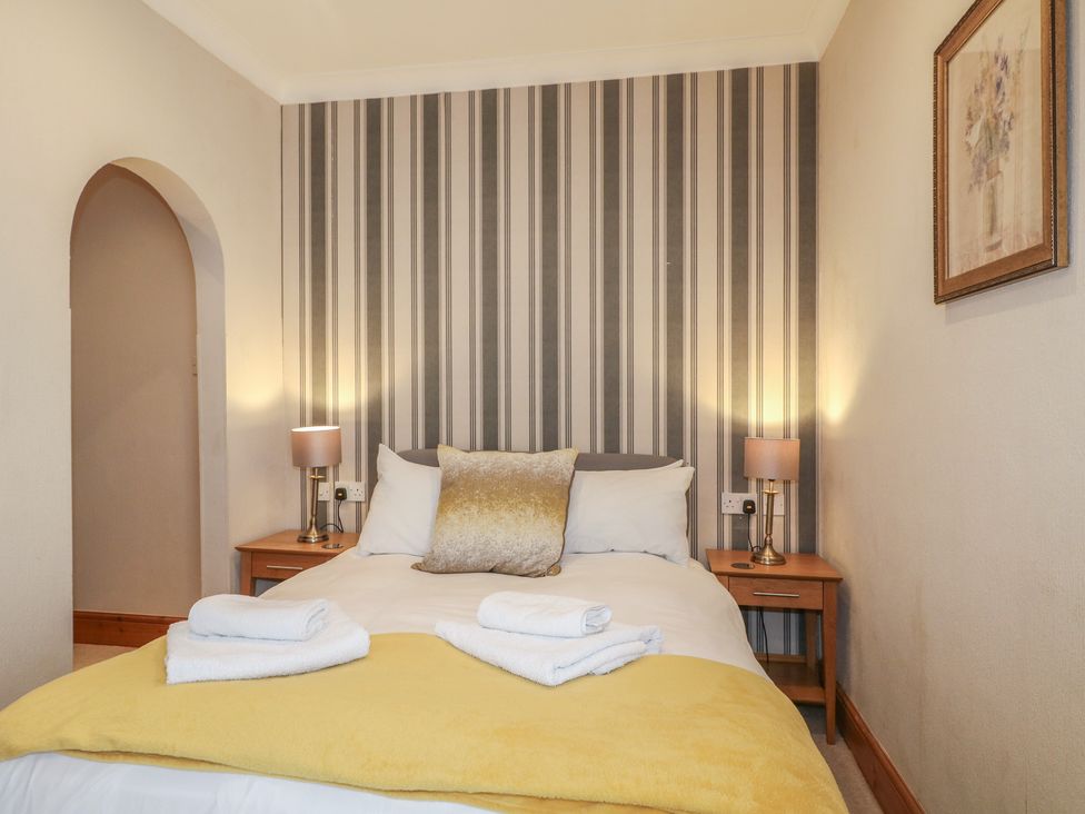 A bedroom with a bed and nightstand at Hambleton House, Castle Donington