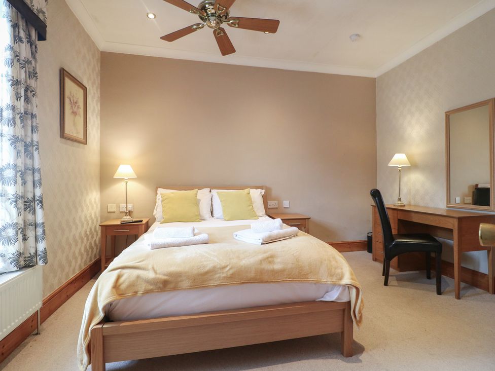 A bedroom with a bed and desk at Hambleton House Castle Donington