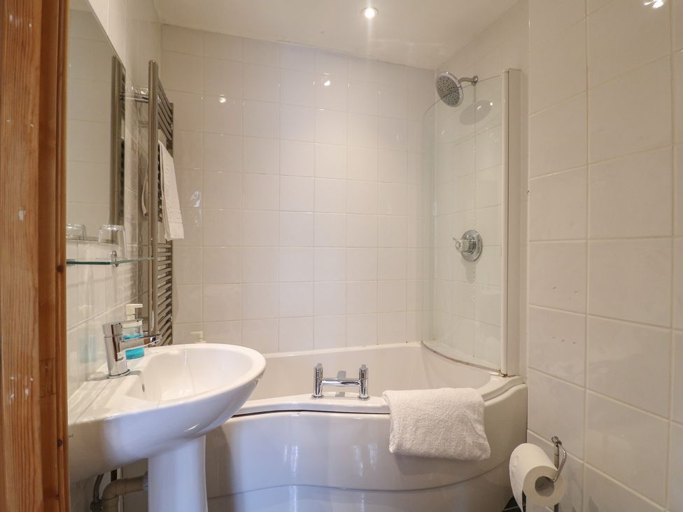 A bathroom with a sink, bathtub, and shower at Hambleton House in Castle Donington