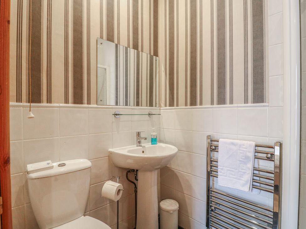 A bathroom with a toilet and sink at Hambleton House in Castle Donington