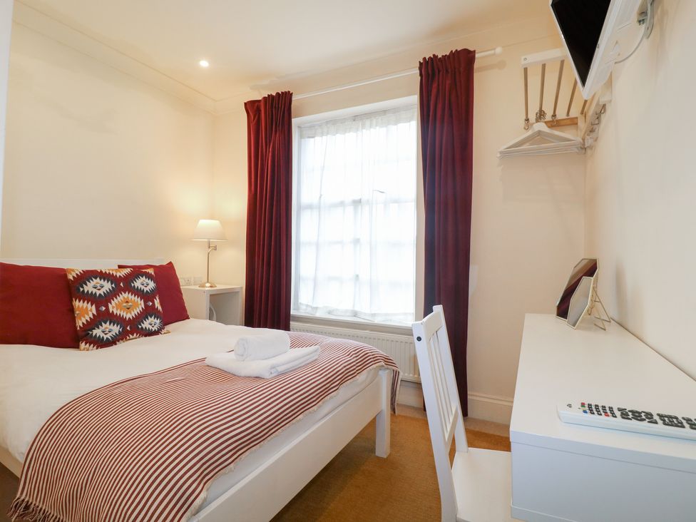 A bedroom with a bed and desk at Hambleton House, Castle Donington