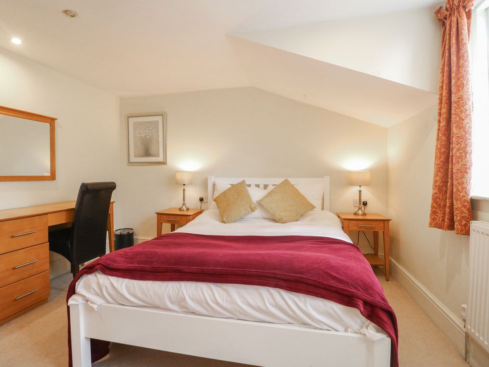 A bedroom with a bed and desk at Hambleton House in Castle Donington