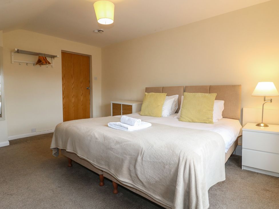 A bedroom with a bed and bedside table at Hambleton House in Castle Donington