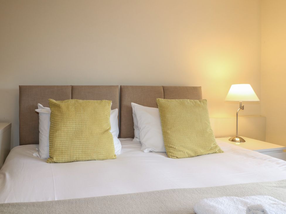 A bedroom with a bed and lamp at Hambleton House in Castle Donington