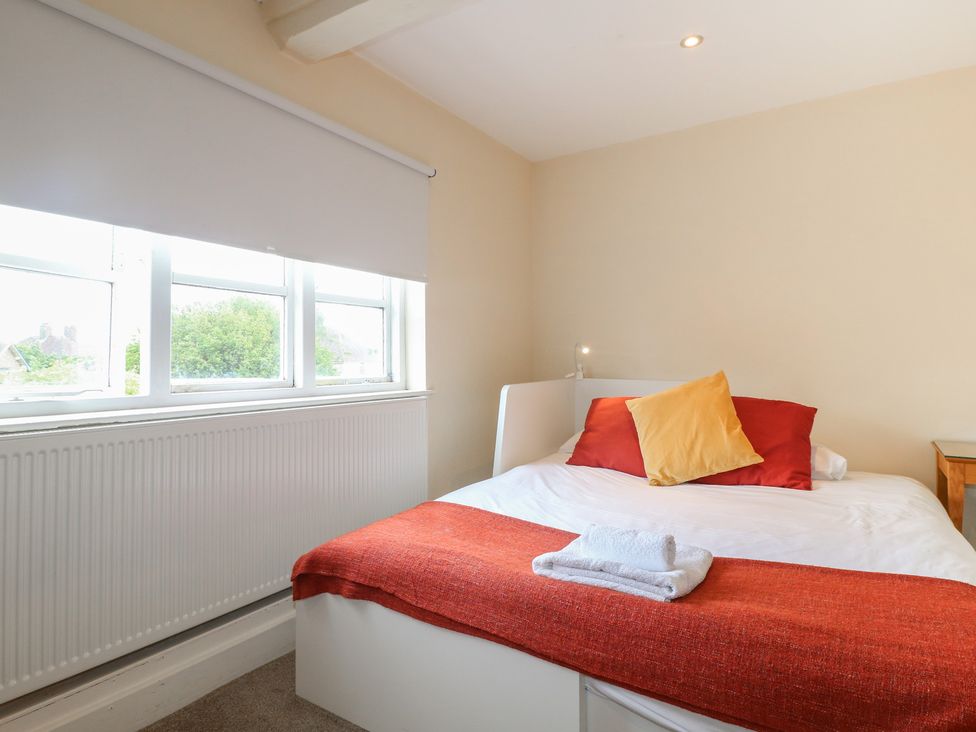 A bedroom with a bed and window at Hambleton House in Castle Donington