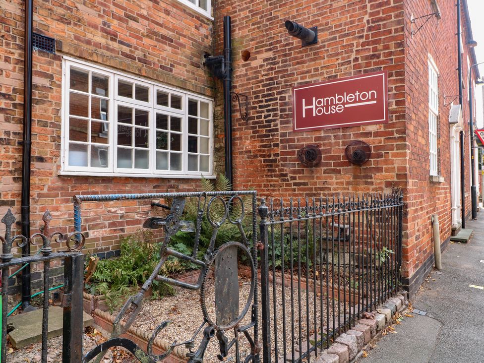 An exterior view of Hambleton House showing a brick wall and window in Castle Donington