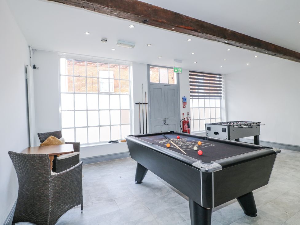 A game room with a pool table and a foosball table at Hambleton House in Castle Donington