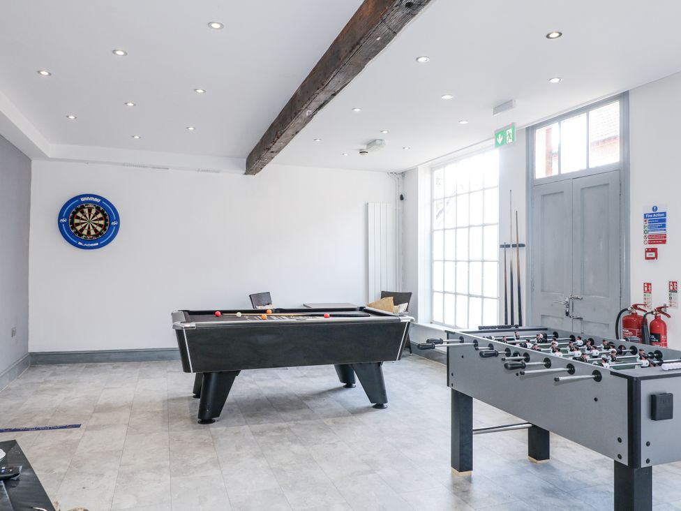 A game room with a pool table and foosball table at Hambleton House in Castle Donington