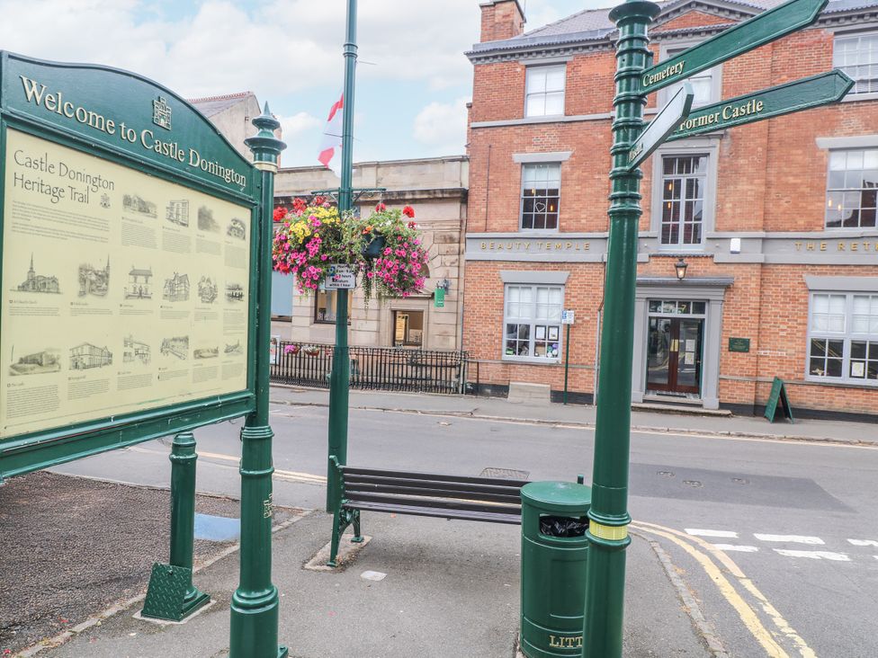 An information board and bench on the street at Hambleton House in Castle Donington