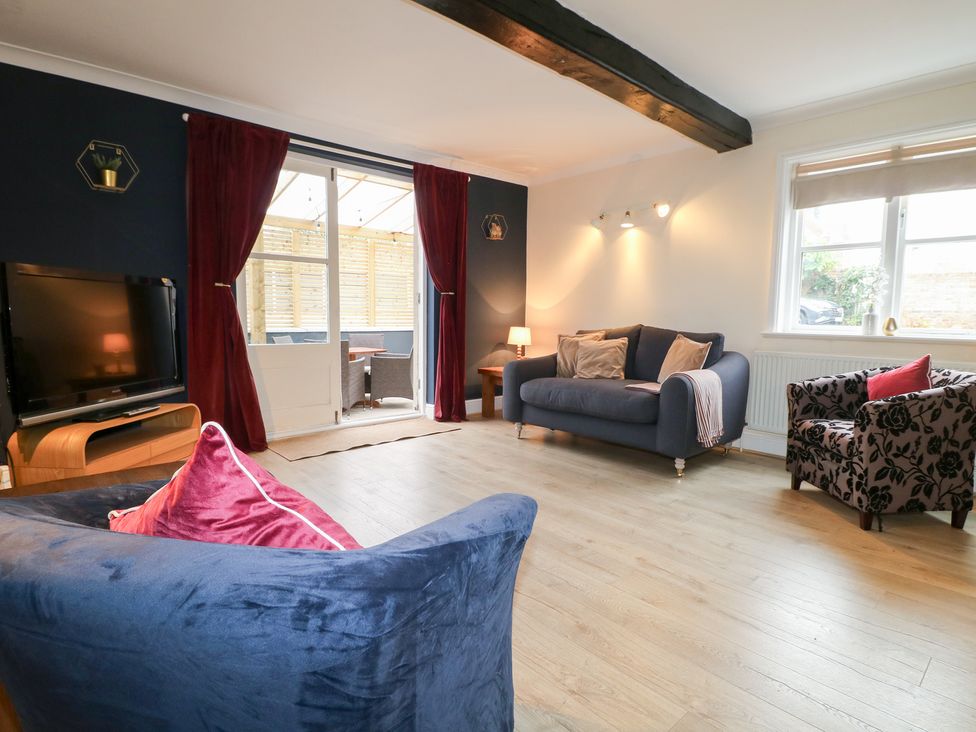 A living room with a television and sofas at Hambleton House in Castle Donington