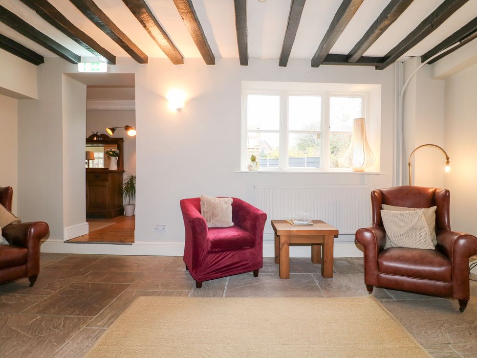 A living room with armchairs and a coffee table at Hambleton House in Castle Donington