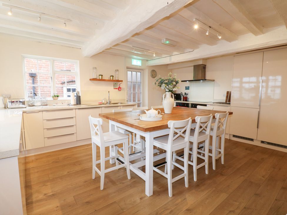 A kitchen with an island and seating at Hambleton House in Castle Donington
