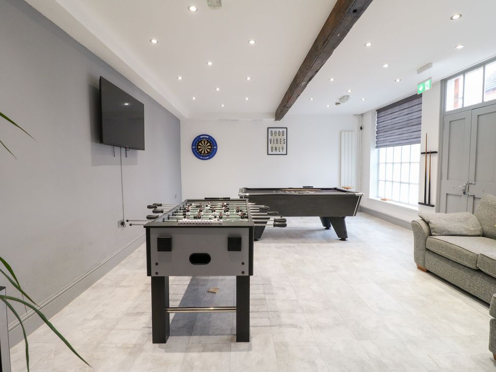 A game room with foosball table and pool table at Hambleton House in Castle Donington