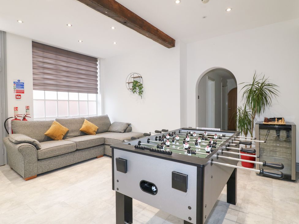 A game room with a football table and a sofa at Hambleton House in Castle Donington
